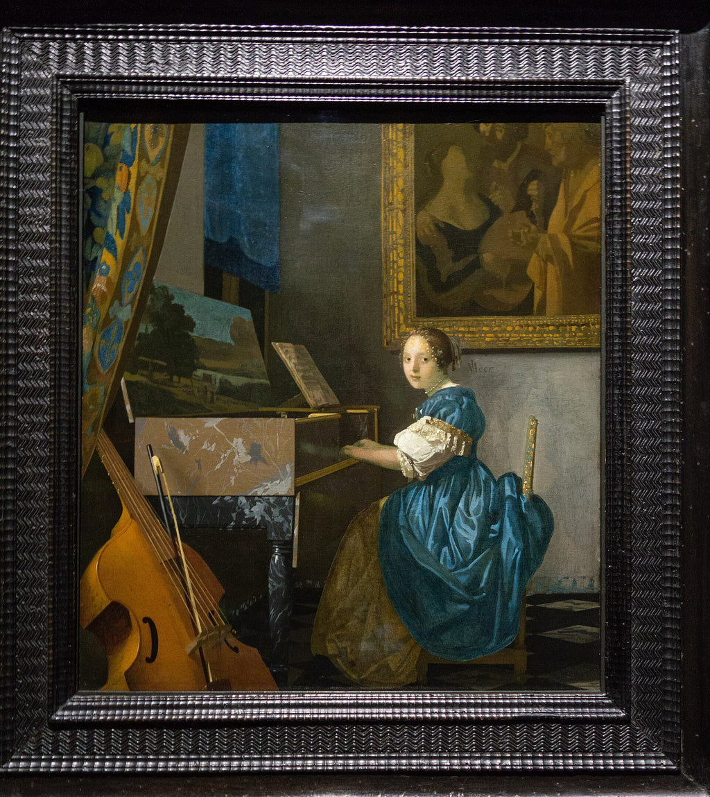 Ung kvinne som spiller på virginalet - Johannes Vermeer