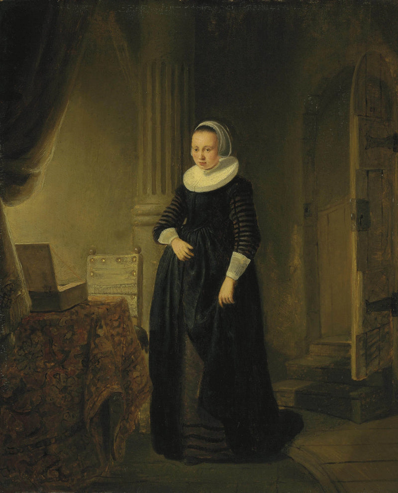 Portrett av en kvinne, stående i helfigur i et interiør - Rembrandt